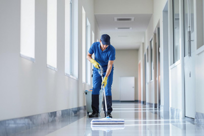 man cleaning floor in newly cleaned building