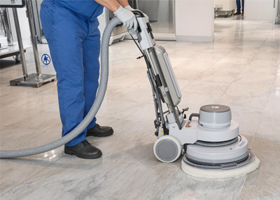 man polishing hard floor with rotary machine