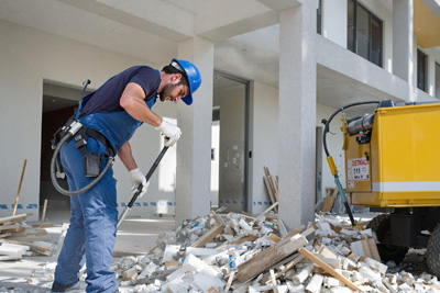 technician removing construction debris